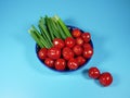 Fresh vegetables are carefully sliced and lie on a plate, cherry tomatoes and green onions Royalty Free Stock Photo