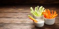 Fresh vegetables - chopped celery sticks and carrots on a wooden background. Royalty Free Stock Photo