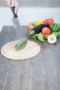 Fresh vegetables on chopping board and dark table. A composition of vegetables