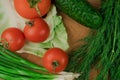 Fresh vegetables on a chopping wooden board, about to turn into a salad. Royalty Free Stock Photo