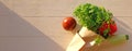 Fresh vegetables in craft paper as bouquet on wooden background, sunlight, top view. Healthy food concept. Banner, copy space Royalty Free Stock Photo