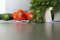 Fresh vegetables cucumbers, tomatoes on the kitchen, gray surface on a linen towel, and green greens dill and parsley are in the Royalty Free Stock Photo