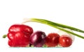 Fresh vegetables with drops of water on a white background, poidor, cucumber, bell pepper, onion, greens