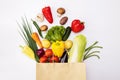 Fresh vegetables in eco friendly paper bag on white background, top view. Food delivery. Grocery shopping. Healthy eating concept Royalty Free Stock Photo