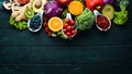 Fresh vegetables and fruits on a black background. Vitamins and minerals. Top view. Royalty Free Stock Photo