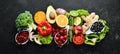 Fresh vegetables and fruits on a black background. Vitamins and minerals. Top view.