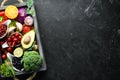 Fresh vegetables and fruits on a black background. Vitamins and minerals. Top view. Royalty Free Stock Photo