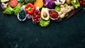 Fresh vegetables and fruits on a black background. Vitamins and minerals. Top view. Royalty Free Stock Photo