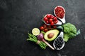 Fresh vegetables and fruits on a black background. Vitamins and minerals. Top view. Royalty Free Stock Photo