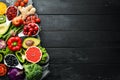 Fresh vegetables and fruits on a black background. Vitamins and minerals. Top view. Royalty Free Stock Photo