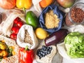 Fresh vegetables and fruits in eco cotton bags and cereals in glass jars on table in the kitchen