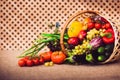 Fresh vegetables, fruits and lettuce in wicker basket Royalty Free Stock Photo