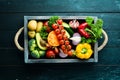 Fresh vegetables and fruits in a wooden box. Avocados, tomatoes, strawberries, melons, potatoes, paprika, citrus. Royalty Free Stock Photo