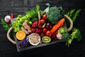 Fresh vegetables and fruits in a wooden box on a black background. Organic food. Royalty Free Stock Photo