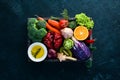 Fresh vegetables and fruits in a wooden box on a black background. Organic food. Royalty Free Stock Photo