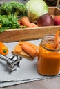 Fresh vegetables and fruits in a wooden box and a glass of carrot juice Royalty Free Stock Photo