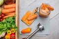 Fresh vegetables and fruits in a wooden box and a glass of carrot juice Royalty Free Stock Photo