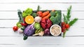 Fresh vegetables and fruits in a wooden box on a white wooden background. Organic food. Royalty Free Stock Photo