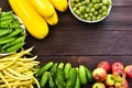 Fresh vegetables. Healthy eating. Zucchini, asparagus, cucumbers, gooseberries, peas on a wooden background. Space for text, top v