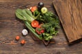 Fresh vegetables and fresh herbs lie on a wooden table Royalty Free Stock Photo