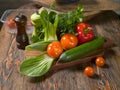 Fresh vegetables and fresh herbs lie on a wooden table Royalty Free Stock Photo