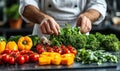 Fresh vegetables and herbs preparation by chef in modern kitchen setting Royalty Free Stock Photo