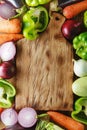 Fresh vegetables and ingredients for cooking around vintage cutting board on rustic background, top view, place for text. Vegan Royalty Free Stock Photo