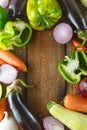 Fresh vegetables and ingredients for cooking around vintage cutting board on rustic background, top view, place for text. Vegan Royalty Free Stock Photo