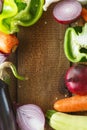 Fresh vegetables and ingredients for cooking around vintage cutting board on rustic background, top view, place for text. Vegan Royalty Free Stock Photo