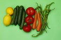 Fresh vegetables isolated on green background. Lemon, tomato, pepper, cucumber and carrot. Royalty Free Stock Photo