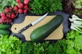 Fresh vegetables and kitchen utensils on wooden background. Top Royalty Free Stock Photo