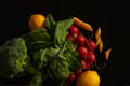 Fresh vegetables lie on black table