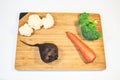 Fresh vegetables lie on a wooden board. Courgettes, carrots, beets, brocali, cauliflower, onions, parsley. Royalty Free Stock Photo