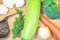 Fresh vegetables lie on a wooden board. Courgettes, carrots, beets, brocali, cauliflower, onions, parsley. Close-up. Royalty Free Stock Photo