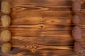 Fresh vegetables like white potatoes and red potatoes. Healthy food frame on wooden background, top view