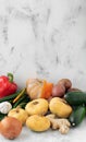 Fresh vegetables for making homemade pumpkin soup on the kitchen table. Close-up, space for recipe text, vertical orientation