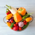 Fresh vegetables in metal colander over white. Royalty Free Stock Photo