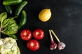 Fresh vegetables organic food for healthy eating on dark background with copy space for your text. Tomato cucumber cabbage spinach Royalty Free Stock Photo