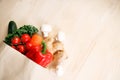 Fresh vegetables in paper bag on light wooden background Royalty Free Stock Photo