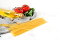 Fresh vegetables, pasta, spaghetti with olive oil set. Olive oil, garlic, dill, parsley, spices on white background