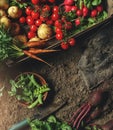 Fresh vegetables, potato, radish, tomato, carrot, beetroot in wooden box on ground on farm at sunset. Freshly bunch harvest.