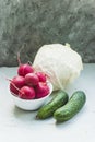 Fresh vegetables, radish cabbage, cucumber not on a medium gray background Royalty Free Stock Photo