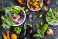 Fresh vegetables - radishes, eggplant, pepper, tomatoes, onion, garlic on a dark wooden background.