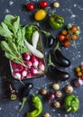 Fresh vegetables - radishes, tomatoes, peppers, onions, garlic, eggplant on a dark background, top view. Raw ingredients Royalty Free Stock Photo