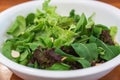 Vegetables salad in white bowl on table