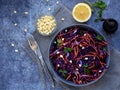 Fresh vegetables salad with purple cabbage, carrot, sprouted mung, parsley on grey clay plate on dark background. Cole Slaw Salad Royalty Free Stock Photo