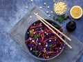 Fresh vegetables salad with purple cabbage, carrot, sprouted mung, parsley on grey clay plate on dark background. Cole Slaw Salad Royalty Free Stock Photo