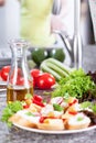 Fresh vegetables and sandwiches on granite worktop