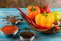 Fresh vegetables, . Sweet red, yellow, green, orange pepper in basket on wooden background. Red pepper spice and black pepper