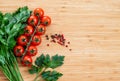 Fresh vegetables on the table, copy space. Food background. Flat lay. Cherry tomatoes, a bunch of parsley, black and red peppers Royalty Free Stock Photo